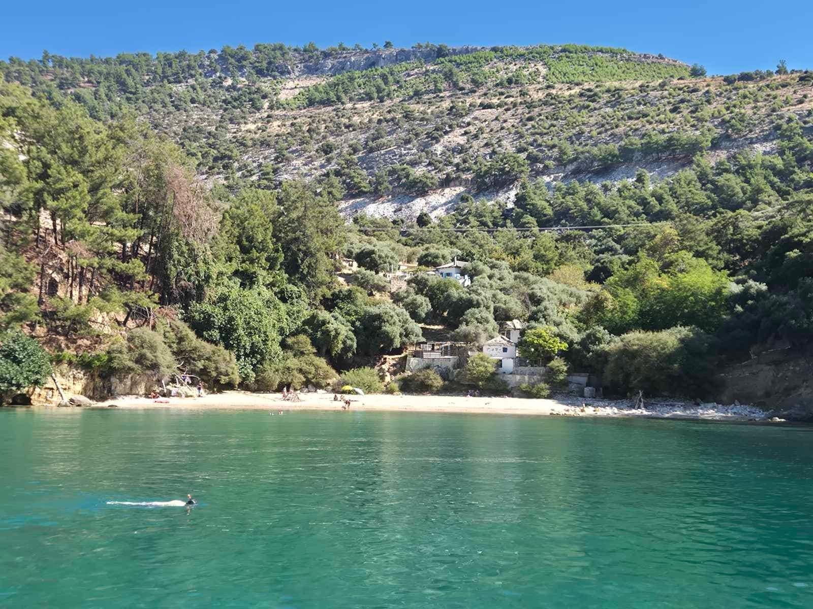 A green bay with a small beach and calm water