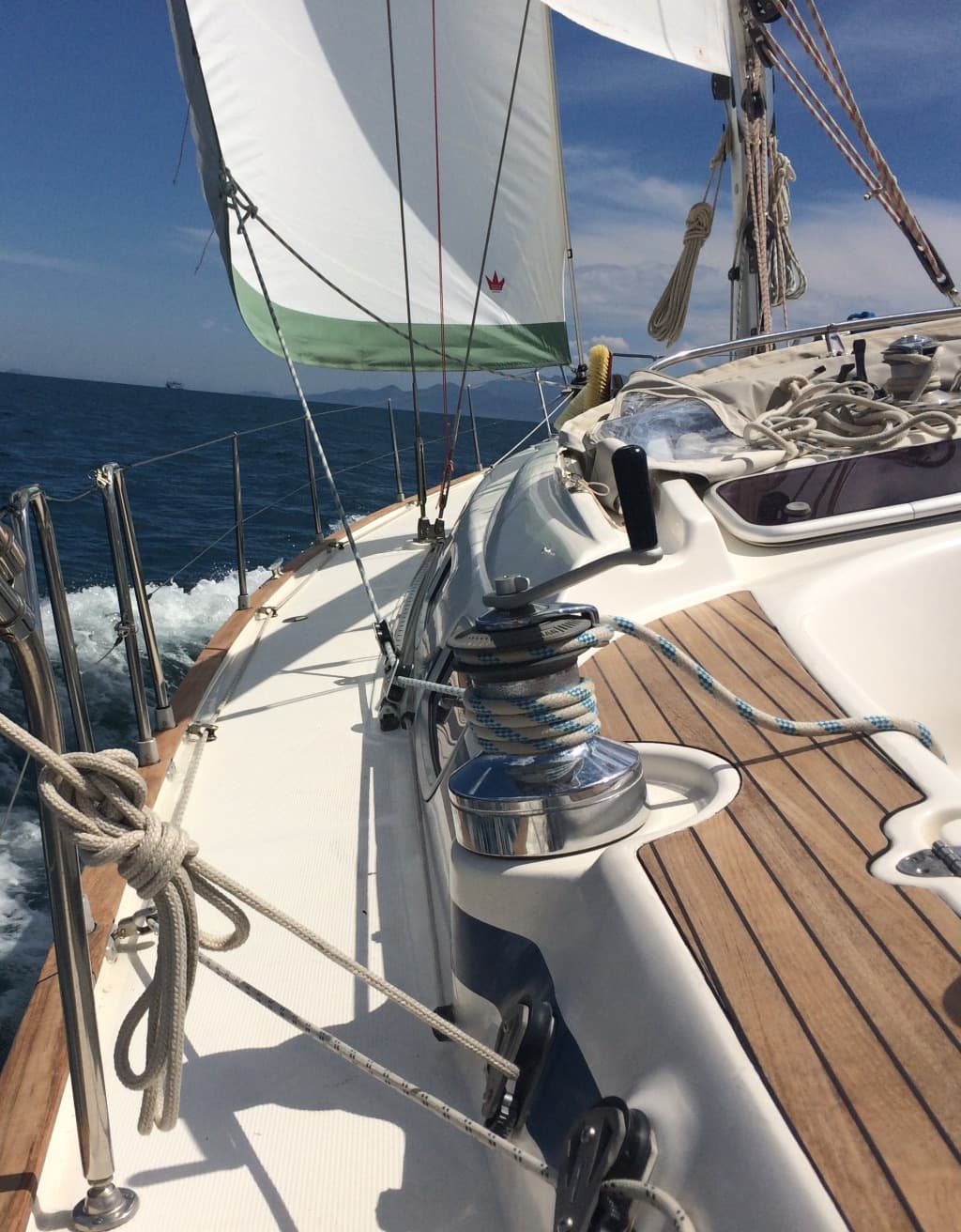 The teak deck and a winch while sailing