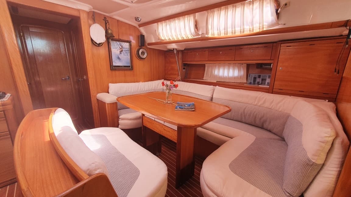 The saloon with its U shaped sofa and wooden table