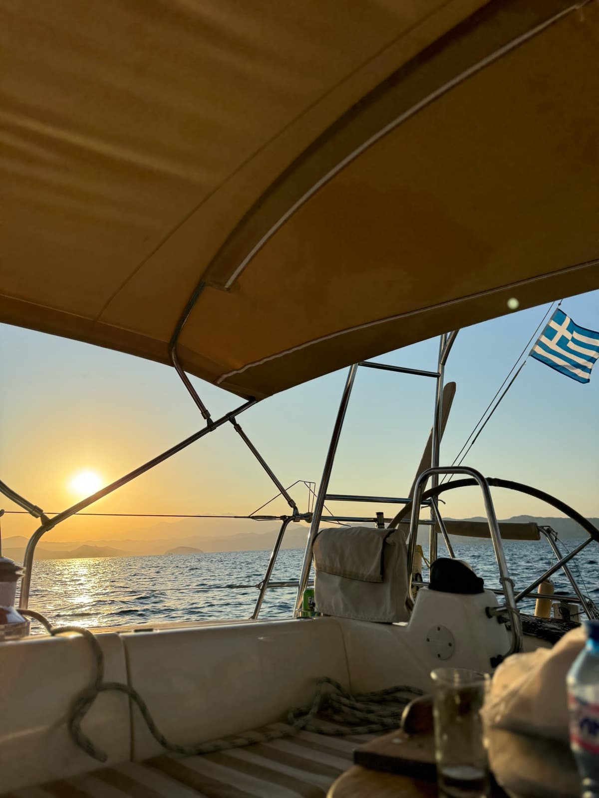 Sunset from the helm, with the Greek flag at the stern
