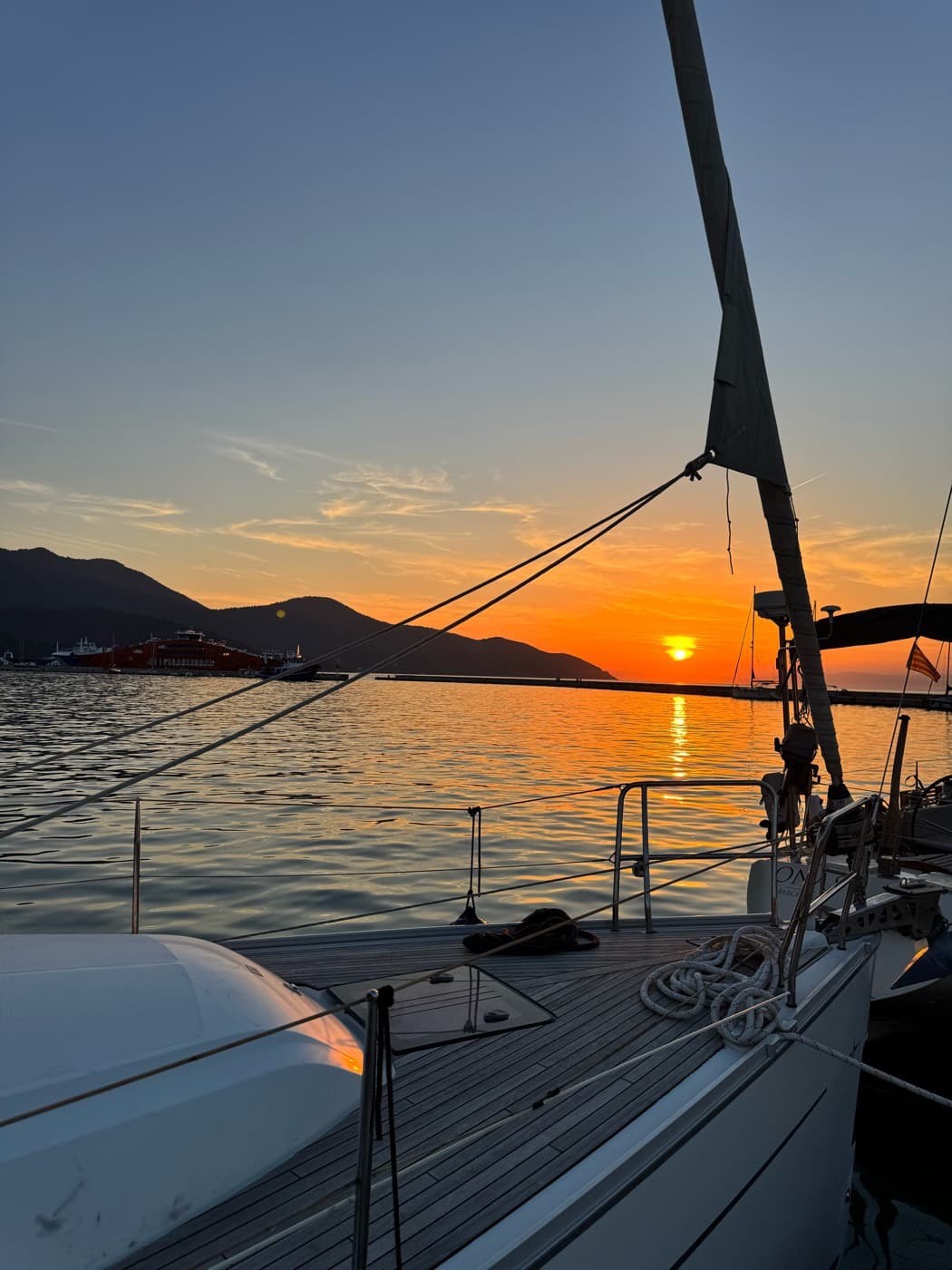 The sun setting over the hills, seen from the deck at anchor