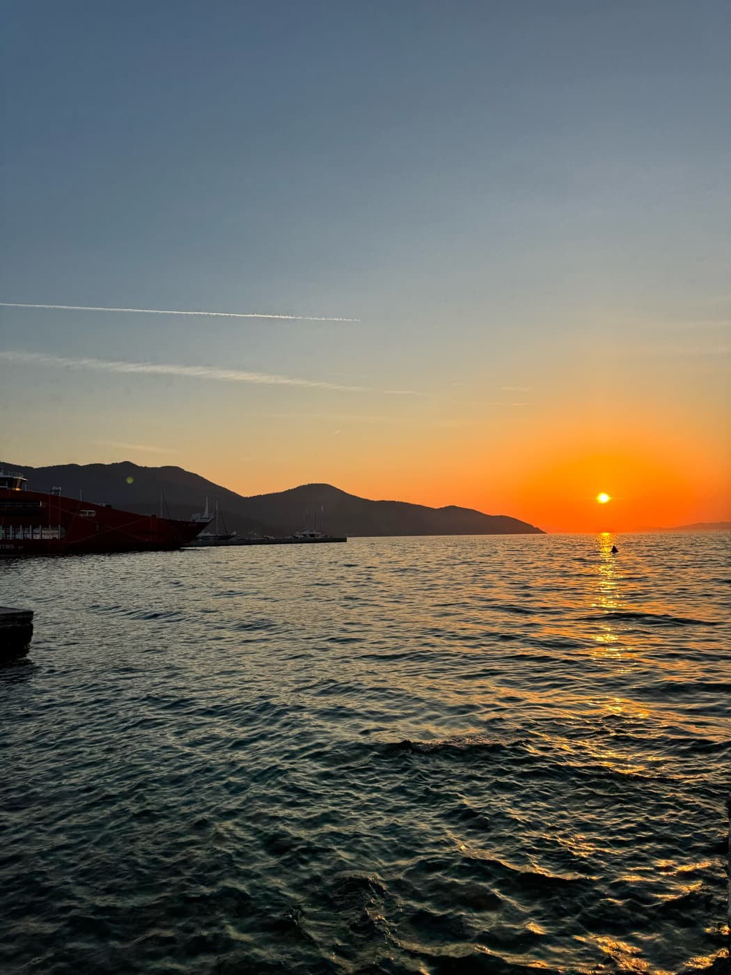 The sun setting over the open sea