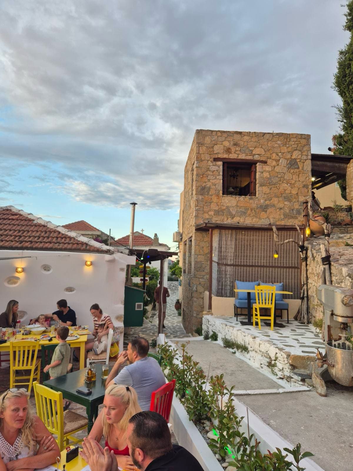 Guests at a taverna in an island village in the evening
