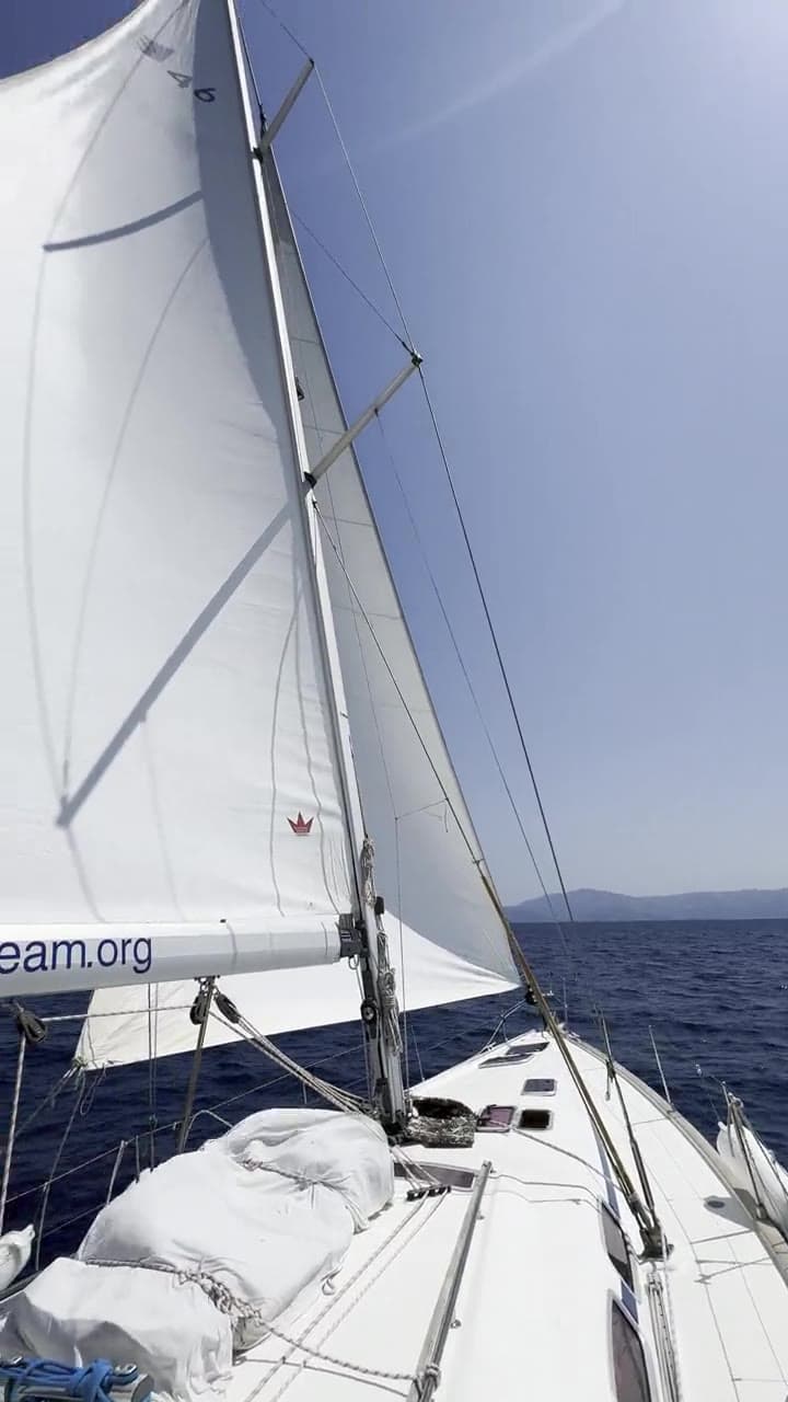 Full sails seen from the foredeck on a clear day